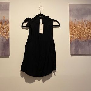 Black Shirt, Bow tie on right shoulder, ruffled neck line.